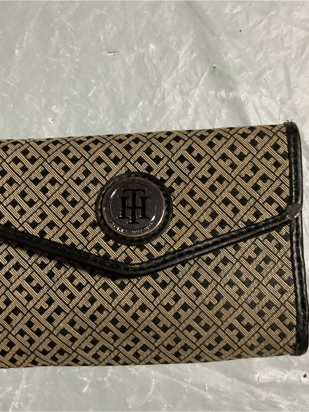 Tommy Hilfiger Beige and Black Monogram Clutch Wallet It has some scuff marks.